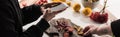 Cropped view of two professional photographers making food composition for commercial photography on smartphone on wooden table Royalty Free Stock Photo