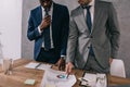 Cropped view of two stylish businessmen doing