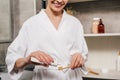 cropped view of woman applying toothpaste on toothbrush from tube Royalty Free Stock Photo