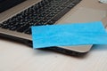 Cropped view of woman cleaning screen of laptop with napkin near notebooks on blurred background on table Royalty Free Stock Photo