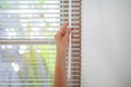Woman pull rope, closed modern white  blinds Royalty Free Stock Photo