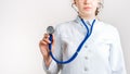Cropped view of Woman Doctor in uniform standing and holding a stethoscope. Copy space Royalty Free Stock Photo