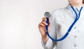 Cropped view of Woman Doctor in uniform standing and holding a stethoscope. Copy space Royalty Free Stock Photo