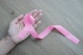 Cropped view of woman hand with pink ribbon for breast cancer awareness Royalty Free Stock Photo