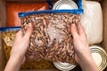 Cropped view of woman holding beans in zipper bag