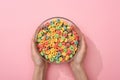 Cropped view of woman holding bright colorful breakfast cereal in bowl Royalty Free Stock Photo