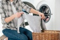 cropped view of woman holding clothes near washer Royalty Free Stock Photo