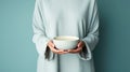 cropped view of woman holding cup of tea isolated on turquoise Generative AI Royalty Free Stock Photo