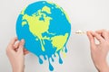Cropped view of woman holding paper globe and match with fire on white, global warming concept Royalty Free Stock Photo