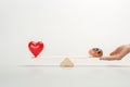 Cropped view of woman holding seesaw with human brain and red heart Royalty Free Stock Photo