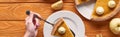 Cropped view of woman holding spatula with piece of pumpkin pie with whipped cream near cut and whole apples on orange Royalty Free Stock Photo