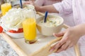 cropped view of woman holding tray with yogurt and orange juice Royalty Free Stock Photo