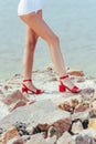 cropped view of woman legs in stylish red heeled sandals Royalty Free Stock Photo