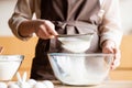 Cropped view of woman sieving flour