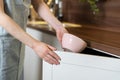 Woman puts clean ceramic dishes in the cupboard Royalty Free Stock Photo