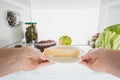 Cropped view of woman taking cheese from fridge with fruits and pickles isolated on white Royalty Free Stock Photo