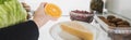 Cropped view of woman taking orange slice from fridge with food  on white, panoramic shot Royalty Free Stock Photo