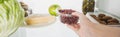 Cropped view of woman taking plastic tray with currant from fridge with food Royalty Free Stock Photo