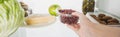Cropped view of woman taking plastic tray with currant from fridge with food  on white, panoramic shot Royalty Free Stock Photo
