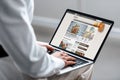 Cropped view of woman using laptop with bbc food website