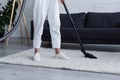 Cropped view of woman vacuuming carpet Royalty Free Stock Photo