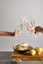 Cropped view of women clinking champagne