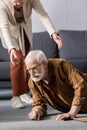 Cropped view of woman helping fallen