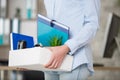 cropped view worker leaving office carrying their possessions