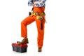 Cropped view of workman in orange overall leaning on tool box