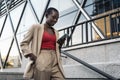 Cropped view of a young adult woman walking down stairs using phone in the city Royalty Free Stock Photo