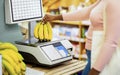 Cropped view of young black woman weighing bananas on scales at supermarket, closeup Royalty Free Stock Photo