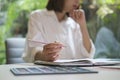 Cropped view of young female graphic designer working with colour swatch samples and modern devices at office Royalty Free Stock Photo