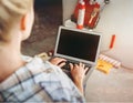 Cropped view of Young girl designer with laptop works in the repair place in the house. Choosing design new apartment concept Royalty Free Stock Photo