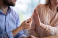 Cropped view of young lady refusing marriage proposal, gesturing NO to man with engagement ring, indoors Royalty Free Stock Photo