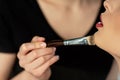 View of young makeup artist applying concealer on model Royalty Free Stock Photo