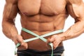 Cropped view of young muscular man with measuring tape Royalty Free Stock Photo