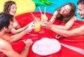 Cropped view of young people drinking fruit cocktails at pool party - Luxury vacation concept with guys and girls having fun Royalty Free Stock Photo