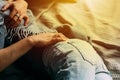 Cropped view of youngcouple embracing and relaxing on bed at home. Vintage casual look. Torn blue jeans. Winter time