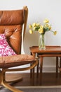 Cropped vintage tan leather chair with teak side tables