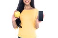 cropped white of smiling african american girl holding apple and smartphone with blank screen isolated