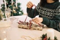 Cropped woman preparing present in winter holiday decor Royalty Free Stock Photo