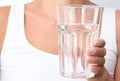 Cropped woman showing glass of pure water