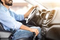 Cropped young bearded man in casual driving nice car