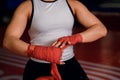 Cropped young boxing woman binds the bandage on hand before training Royalty Free Stock Photo
