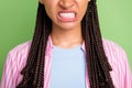 Cropped of young unhappy upset angry afro american woman show teeth aggressive isolated on green color background