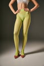 cropped young woman in green tights