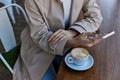 cropped young woman in trench coat