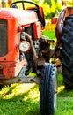 Old vintage red tractor standing on a farm field at sunset. Royalty Free Stock Photo