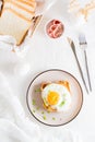 Croque madam - french sandwich with cheese, ham and egg on a plate on a light table. Top and vertical view Royalty Free Stock Photo