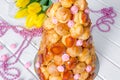 Croquembouche with pink roses and caramel threads.